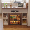 Wooden kitchen island with shelves displaying various items in a modern kitchen setting.